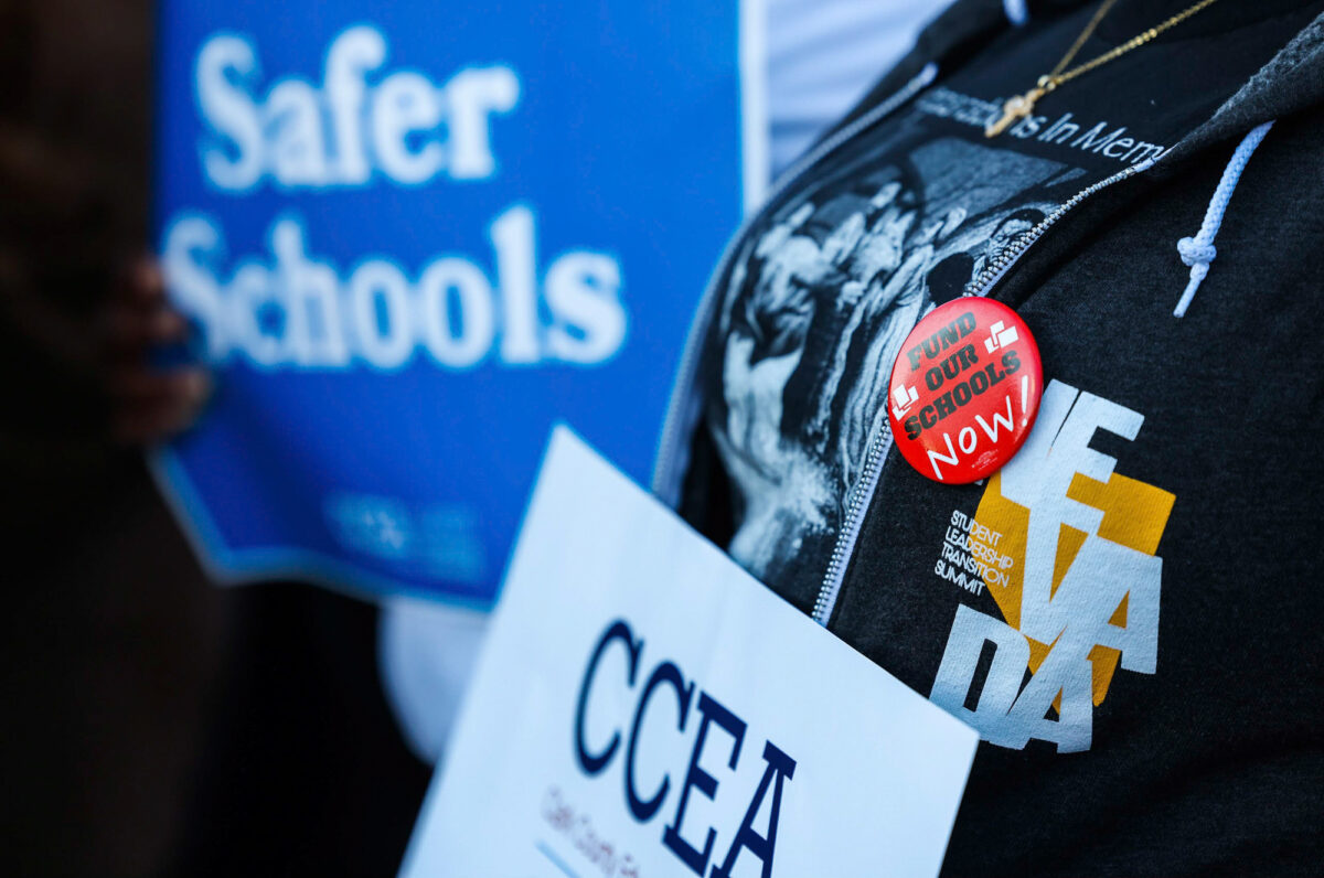 Members of the Clark County Education Association rally in front of the Grant Sawyer State Office Building on Monday, Feb. 6, 2023,  (Jeff Scheid/The Nevada Independent)